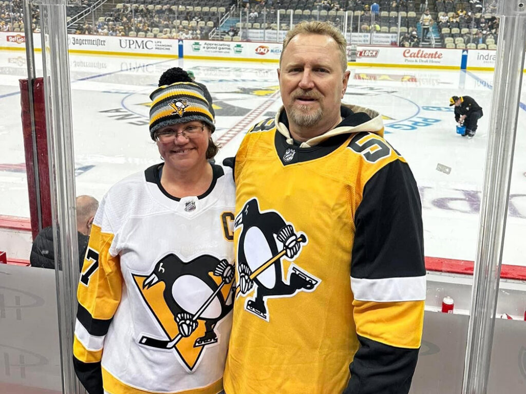 Jim Olson and wife at Hockey game