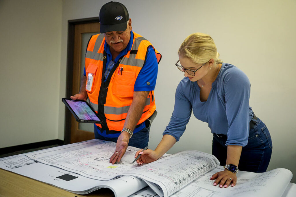 man and women reviewing site plans