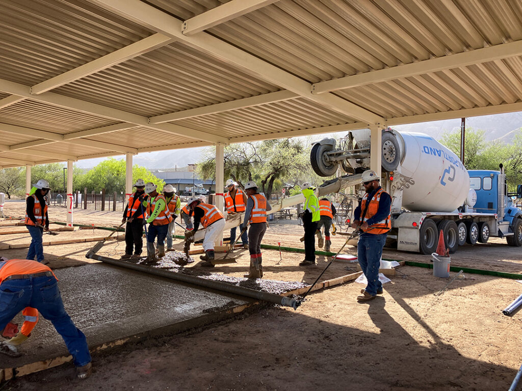 construction workers pouring concrete