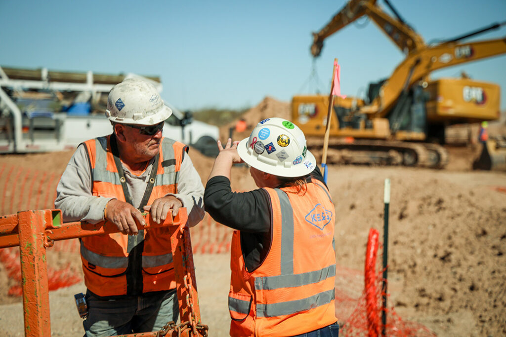 two workers collaborating on a construction site
